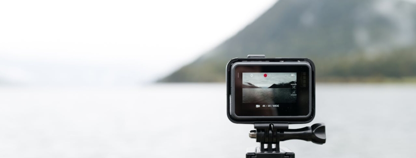 A photo of a GoPro camera shooting video of a body of water